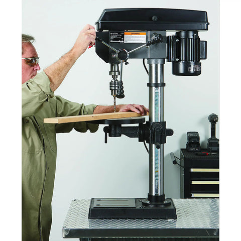 Man using 13 In Benchtop Drill Press With 3/4 HP 120V 5/8 In Chuck 1 In Drilling Capacity 16 Speeds From 220 To 3,300 RPM
