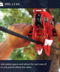 Heavy Duty Zipline Trolley With Stainless Steel Sheaves And Double Pulley, 23kN Rating, held by hands in outdoor setting