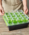 Person placing lid on SuperSeed All In One Seed Starting Tray With 16 XL Cells, Reusable And Dishwasher Safe, Indoor Grow Kit.