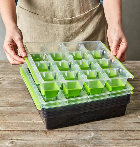 Person placing lid on SuperSeed All In One Seed Starting Tray With 16 XL Cells, Reusable And Dishwasher Safe, Indoor Grow Kit.