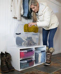 Woman organizing closet with Clear 32 Qt Stackable Storage Bins With Lids 6 Pack for Closet and Laundry Organization on shelf