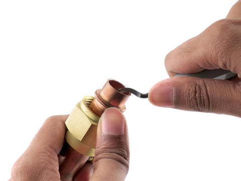 Swivel Head Deburring Tools Set With 5 Inch Aluminum Handle, Hardened Steel Blades in use on copper pipe