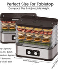 No Sweat Compact Food Dehydrator For Crafting Homemade Beef Jerky Crispy Banana Chips Dried Oregano Leaves And Handcrafted Puppy Bites on tabletop with fruit and herbs.