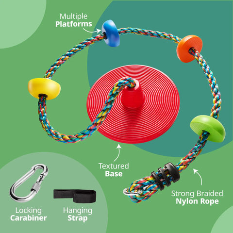 Red Disc Seat Swing For Kids With Easy Install Rainbow Climbing Rope Carabiner And 4 Foot Strap Treehouse Style Outdoor Playground Accessory For Backyard Fun, showing multicolor platforms and textured base.