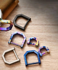 Various multicolor Alloy Miniature Keychain Clip With Detachable Tool And Screwdriver on a wooden surface.