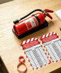 Fire extinguisher on table with 25 Pack Fire Extinguisher Tags With Adjustable Wire Ties For Monthly Inspections 2026 2033 visible