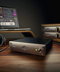 UAD 2 Satellite Quad Core Thunderbolt 3 DSP Interface for Mac and PC on a studio desk with headphones and a laptop