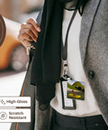 Person wearing Cartoon Man On Ocean Rowing Inflatable Raft Key Chain on lanyard, scratch resistant high-gloss key chain.