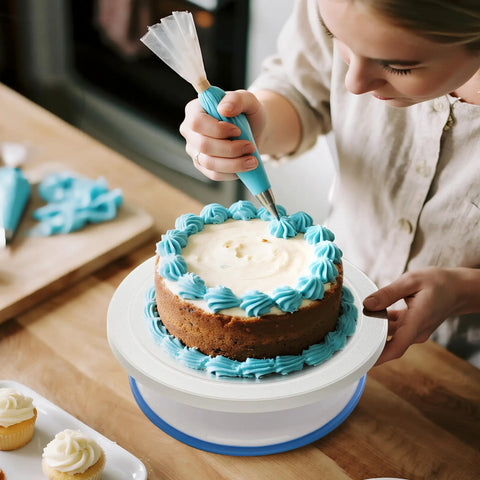 Person using All In One Cake Decorating Starter Kit With Non Slip Turntable Leveler And 82 Piece Baking Gear Including Piping Tips Icing Bags