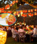 Outdoor party with string lights and autumn leaf decorations at dusk