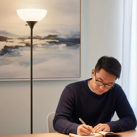 Sky Dome Dimmable LED Floor Lamp in Jet Black Finish lighting a man writing in a calm living room setting