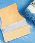Three Piece Flat Wool Brush Set With Poplar Wood Handles For Deck Stain And Furniture Paintwork, top view on blue background
