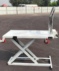 Heavy Duty Hydraulic Forklift And Electric Scissor Lift Table With Four Wheel Elevating Platform for easy loading in warehouse.