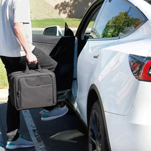 Man carrying XL MTG Bag For Magic The Gathering And Other TCG Accessories With Adjustable Interior Dividers near car