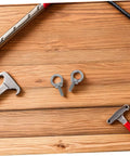 M6x20 Stainless Steel Eyebolts With Closed Ring And Hole For Concrete Anchoring, Beefy Heavy Duty Eye Screws With Nylon Nuts For Vibration Dampening, Super Secure Mounting For Hooks, Decor, And Industrial Projects. Close-up on two M6 eyebolts