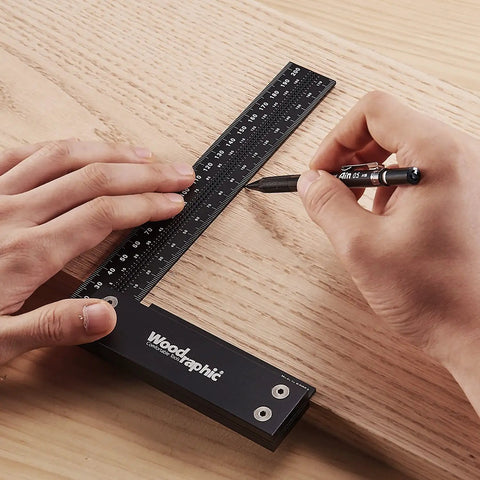 Person using Pro Grade Precision Square Ruler For Marking And Measuring In Carpentry - 4 Inch Aluminum Frame Tool on wood surface