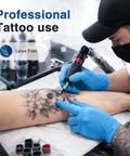 Tattoo artist wearing Blue Vinyl Synthetic Exam Gloves 4 Mil Powder Free Latex Free Non Sterile Disposable Gloves Large 100 Count