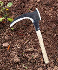 Long Handle Scythe Tool for Yard Work resting on soil, showcasing detachable replaceable blade and wooden handle.