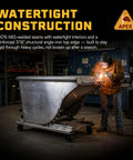 Built Tough 1.5 Yard Self Dumping Hopper With Smooth Rolling Casters And Six Thousand Pounds Capacity in a workshop with watertight construction.
