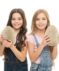 Two girls holding Jumbo Dino Egg Surprise With Twelve Collectible Dinosaurs Inside One Giant Easter Egg For Easter Gifts And Stem Learning Dig Up Jurassic Figures For Boys And Girls
