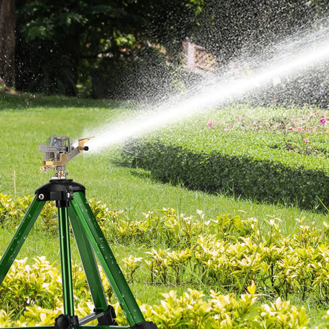 Two Pack 360 Degree Rotary Lawn Sprinklers on Metal Tripod Bases spraying water over a garden, shown with adjustable height and green connectors.