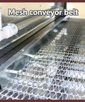 Lgxenzhuo 220V Heat Shrink Tunnel Wrapper With Wide 17.7 In Chamber High Power Quartz Tubes Seals Tray Packaging Fast For Business And Home Projects Reliable Industrial Grade Machine, close-up of metal mesh conveyor belt.