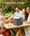 DUMOS countertop ice maker with handle; front view shows black compact unit with a clear lid and ice inside.