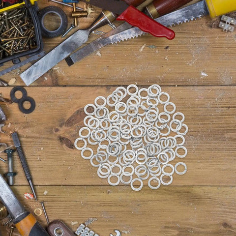 M8 304 Stainless Steel Split Ring Spring Lock Washers for screws and fasteners on a wooden workbench, pack of 100