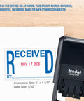 Self Inking Date Stamp Prints Bold Red Dates And Crisp Blue Text To Keep Office Files And Invoicing Totally Streamlined So You Never Have To Sweat Paperwork Again on desk with sample impression.