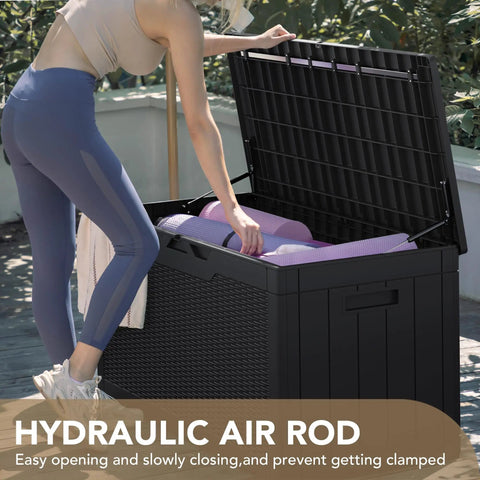 Woman opening 100 Gallon Waterproof Resin Deck Box With Lockable Lid For Patio Cushions And Garden Tools, Large Outdoor Storage Chest, Black Weatherproof