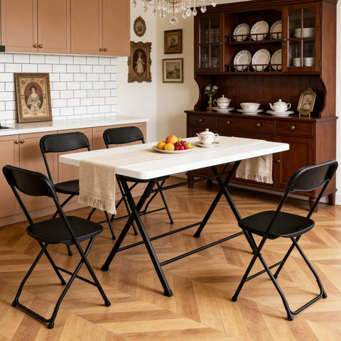 4 Pack Black Plastic Folding Chairs With Steel Frame For Outdoor Use No Fuss Portable Stackable Foldable Seating 350 Lb Capacity For Patio Garden Picnic Kitchen Events shown around a dining table in a kitchen setting