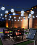 Solar Powered Crystal Globe String Lights 100 LEDs, 72 Ft Outdoor Patio Lights With 8 Modes and solar panel in garden