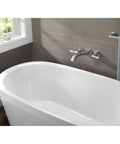 Modern bathroom with freestanding tub and wall-mounted faucet