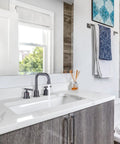 Dark Grey Widespread Brass Bathroom Faucet Set 3 Hole Vanity Tap With Drain And Supply Lines 2 Handle Basin Mixer Taps 3 Pieces Quick Install Fast Connect Durable Satin Finish For Modern Bathrooms installed on white vanity in bright bathroom.