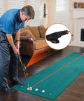 Golfer using Dual Mode Indoor Golf Putting Trainer With Alignment Line on home green mat, red line practice aid for precision putting