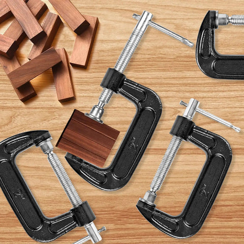 Beefy Eight Piece 2 Inch C Clamp Set, Heavy Duty Steel With Cast Iron Frame And Sliding T Handle, Built For Maximum Stability And Versatility In Woodworking, Welding, Building And Automotive Projects, Durable Black Finish. 2-inch black C clamps holding wood blocks on a bench.