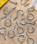 One And A Quarter Inch Bridle Rings 30 Pack Heavy Duty Steel Cable Hangers with Quarter Twenty Threaded on workshop table.