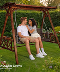 Couple sitting on a bench under a heavy duty six point six foot porch swing frame with adjustable canopy in garden setting