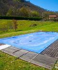Heavy Duty Waterproof Tarp 16x20 Foot Poly Tarpaulin 16 Mil Thick With Metal Grommets covering a pool outdoors