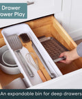 Expandable Sliding Drawer Bin For Kitchens Sets The Bar Inside Deep Drawers in speckled white, organized kitchen utensils in a deep drawer.