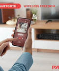 Person streaming music from phone to Beefy Bluetooth PA Mixing Amplifier 500W for home audio in living room setup.