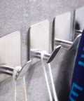 Adhesive Wall Hooks Set For Towels Robes Hats And Clothes Easy Stick On Bathroom And Kitchen Gear Heavy Duty No Drill SUS 304 Stainless Steel Waterproof And Rustproof Round Wide Back Design Four Pack on wall with towel and rope.