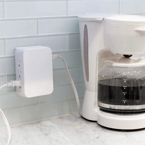 Six Outlet Surge Protector Wall Tap Extender With Side Access, 1500 Joules, next to coffee maker on kitchen counter