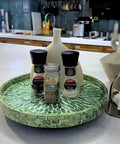Next Level 12.5 Inch Wooden Lazy Susan With Mother Of Pearl Inlay, Super Heavy Duty Spinning Turntable Serving Tray For Kitchen Islands Or Cookouts, Straight Up A Showstopper featuring spices on a green inlaid tray.