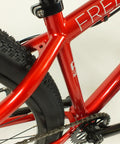 Close-up of Salire SJ-50 Dirt Jumper Bike frame and rear 26-inch wheel, showcasing beefy steel frame and small block tires.