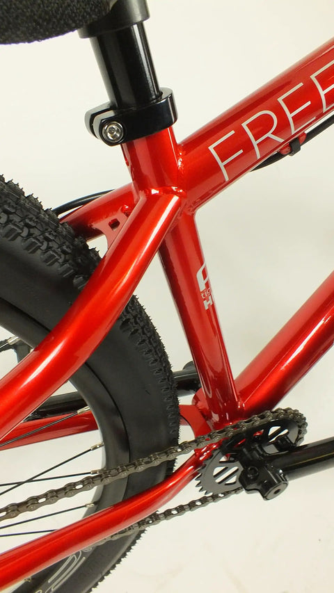 Close-up of Salire SJ-50 Dirt Jumper Bike frame and rear 26-inch wheel, showcasing beefy steel frame and small block tires.