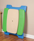 Six Seat Kids Picnic Table With Umbrella Multi Color folded against wall for easy storage in indoor setting