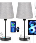 Set of Two Grey Bedside Lamps With USB C Port And AC Outlet 3 Way Dimmable Touch Control Nightstand Lamps For Bedroom Kids Room And Guest Room Built In Dual Charging Station To Power Six Devices, showing charging capability with phone and tablet.