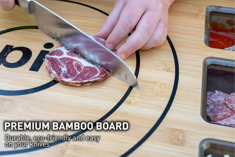 Slicing meat on large bamboo cutting board with 3 shatter resistant containers and lids, board size 45.7 x 60 cm