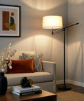 Mid Century Modern Dope Height Adjustable LED Floor Lamp in living room with beige shade and black stand